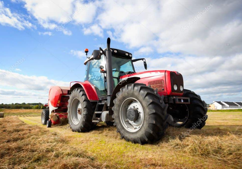 depositphotos_7293286-stock-photo-tractor-collecting-haystack-in-the